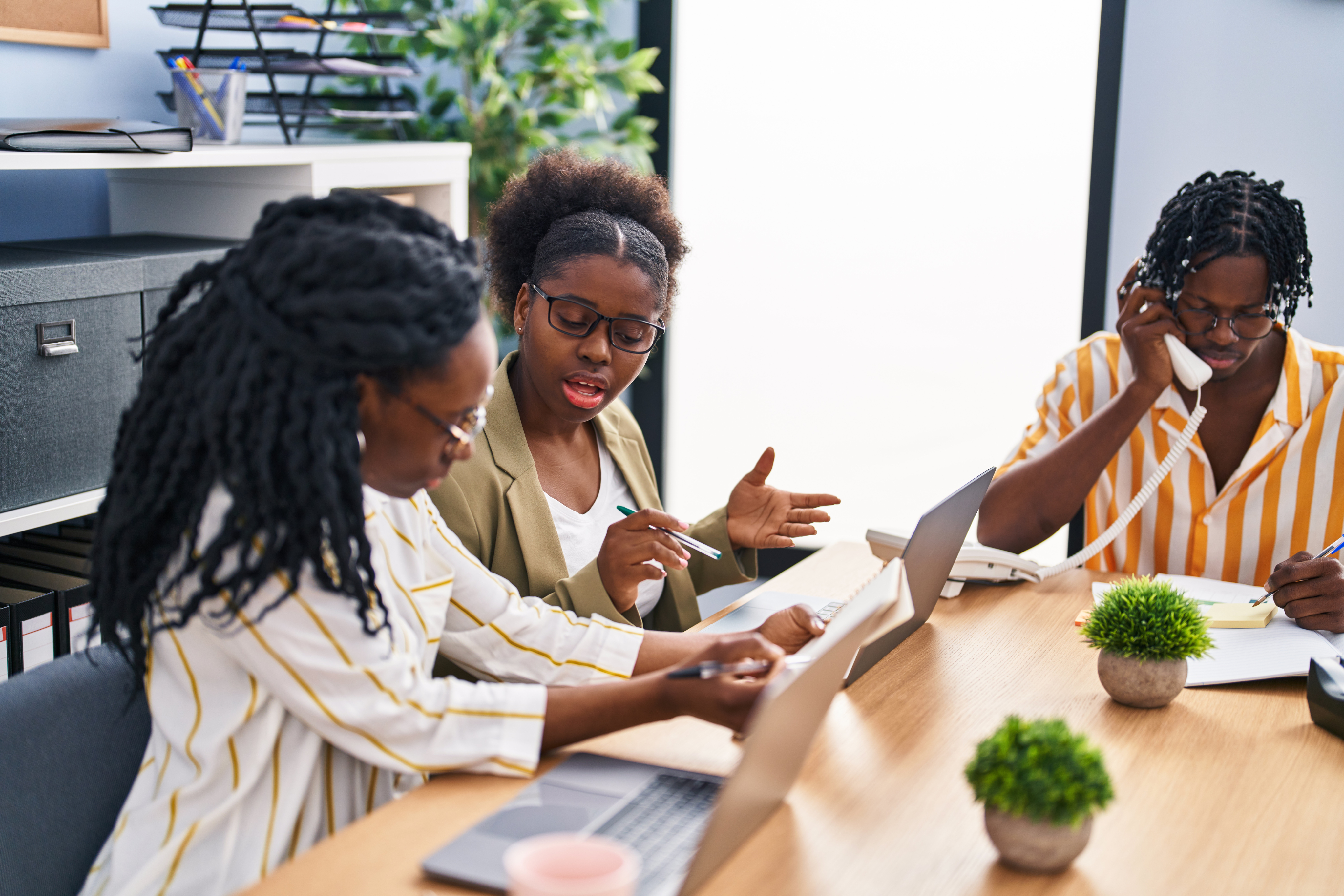 Three women collaborating in a modern office setting