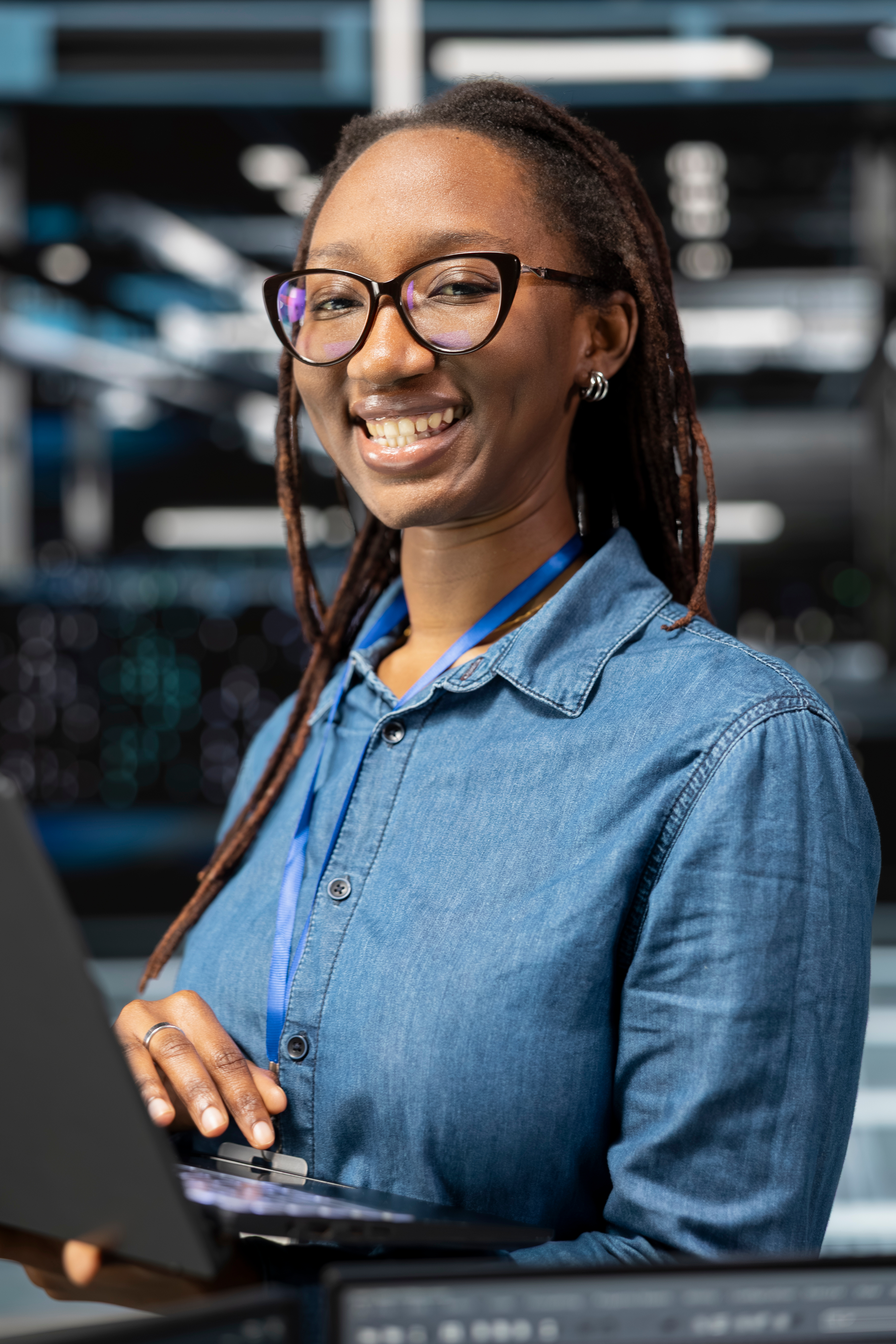 Woman with glasses smiling in modern office setting